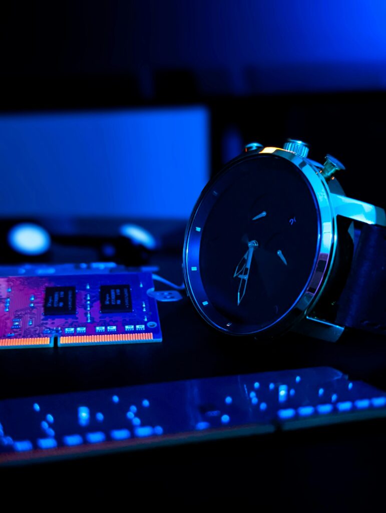 Close-up of a wristwatch with tech components under vibrant blue neon lighting, creating a modern tech vibe.